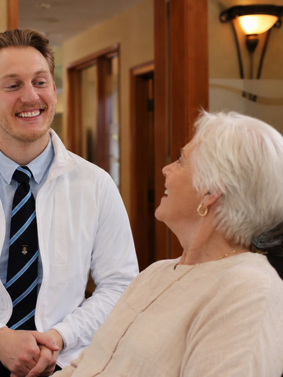 Dentist at Magnolia Smiles laughing with a patient during a friendly consultation in Woodstock, Georgia